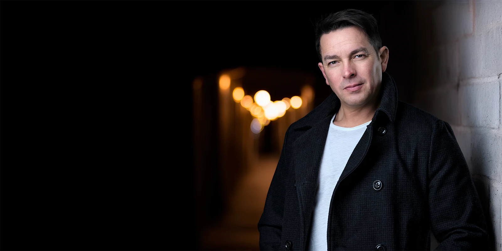 Davey Jones in a darker, cinematic setting with warm background lights