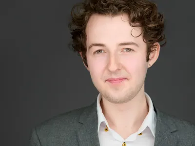 Professional portrait with warm, natural expression and expert lighting