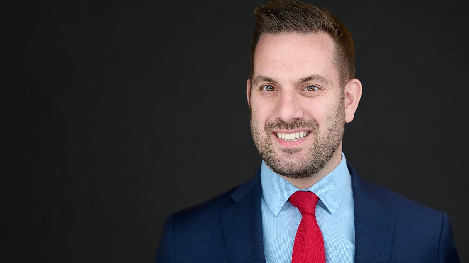 Professional headshot photographer working in Plymouth, showing expert portrait lighting for local business professionals