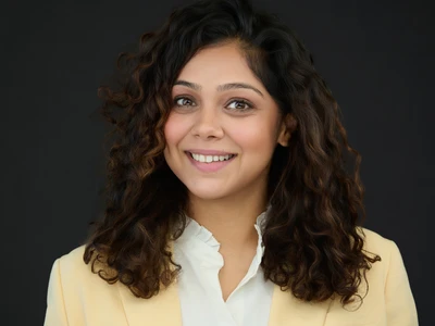 Professional headshot with modern styling, clean background, confident expression