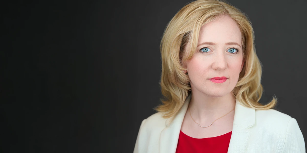 Professional woman in cream jacket and red top, confident and approachable — Bath headshot photographer
