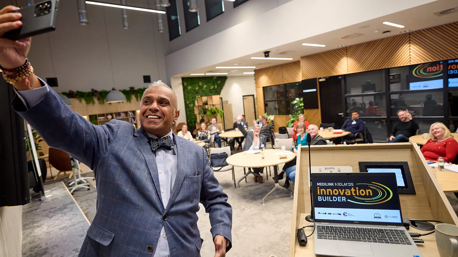 Christian taking a selfie with his audience in the background at the end of a talk