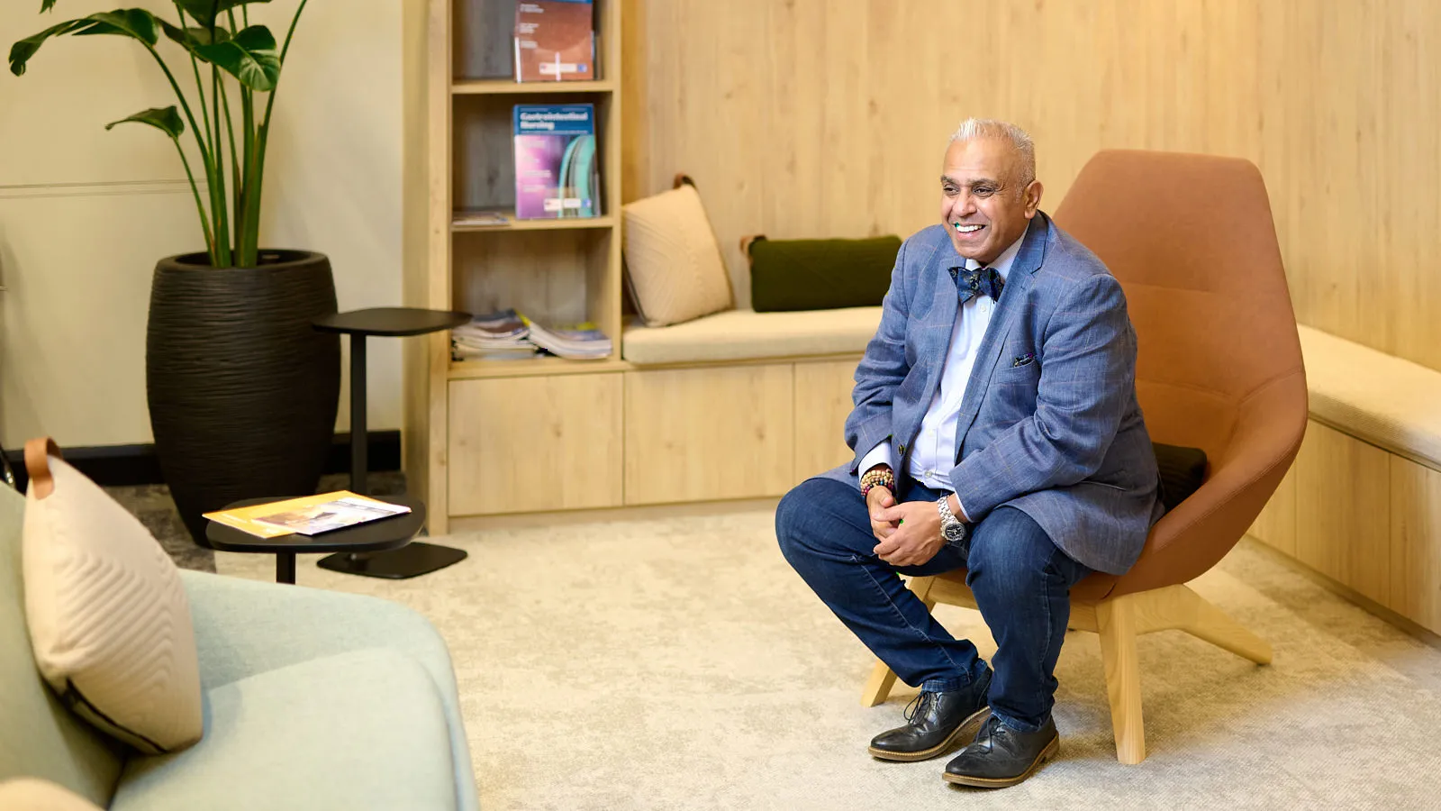 Christian preparing for an interview, seated and reviewing his notes in a professional setting