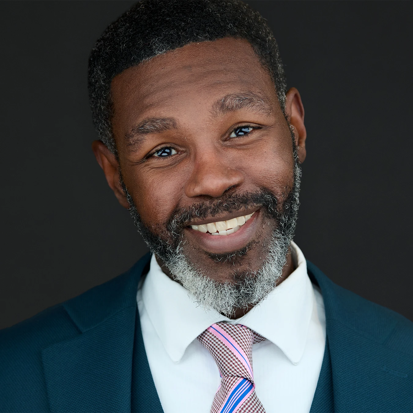 Professional headshot of a London business leader on a dark background with clear space for headline text.