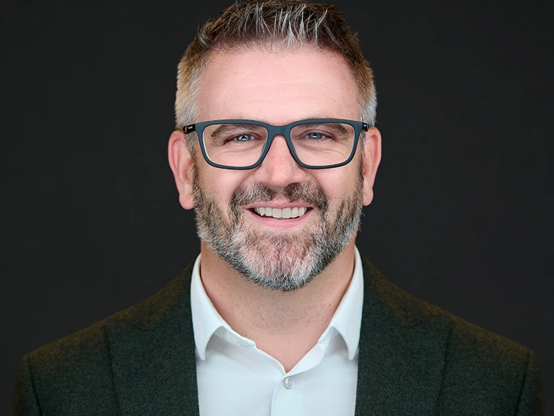 Businessman with natural expression during headshot session, captured on location in London