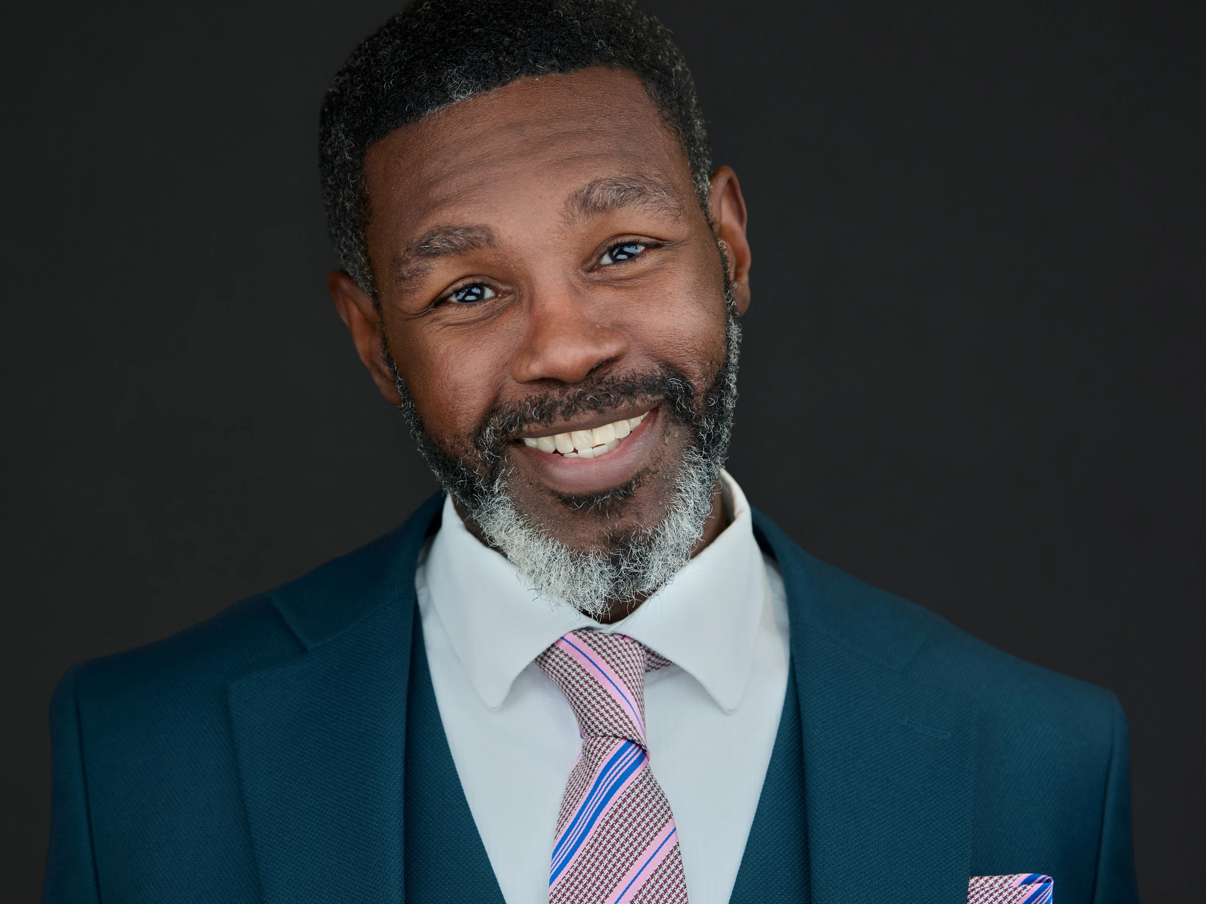 Contemporary Exeter business portrait — natural expression against signature dark background