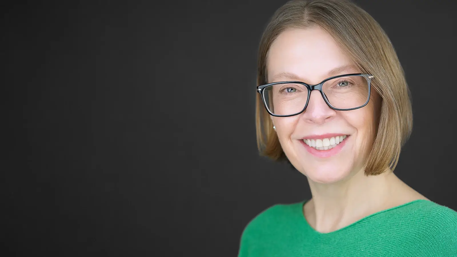 Business professional holding outdated headshot photo next to current appearance, demonstrating obvious need for professional headshot update