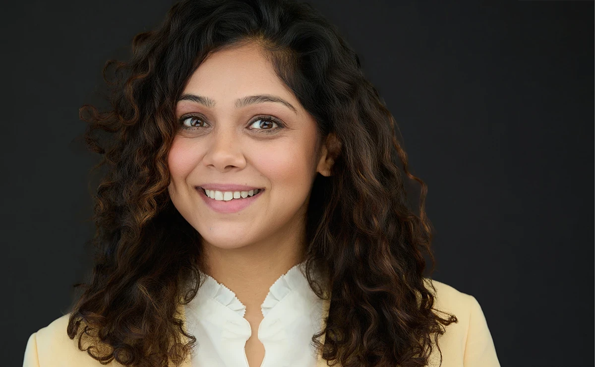 Professional headshot with dark grey background showing how backdrop choice affects confidence and skin tone