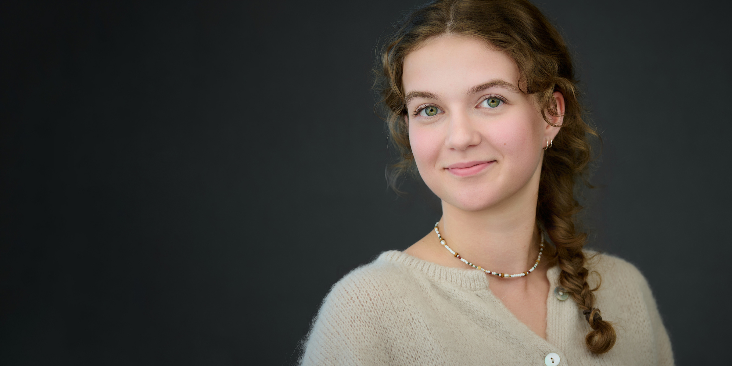 Professional photographer guiding a relaxed business professional during an on-location headshot session in an office