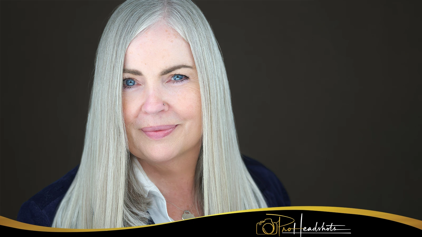 Business professional gaining confidence while watching real-time feedback on computer screen during guided headshot coaching session