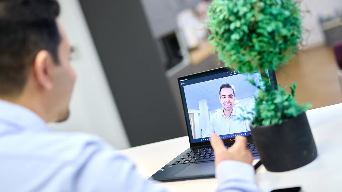 Personal branding photo of a video call, with the professional smiling on a laptop screen