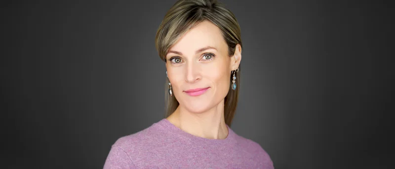 Professional relaxing into a confident expression during a headshot session with live image review