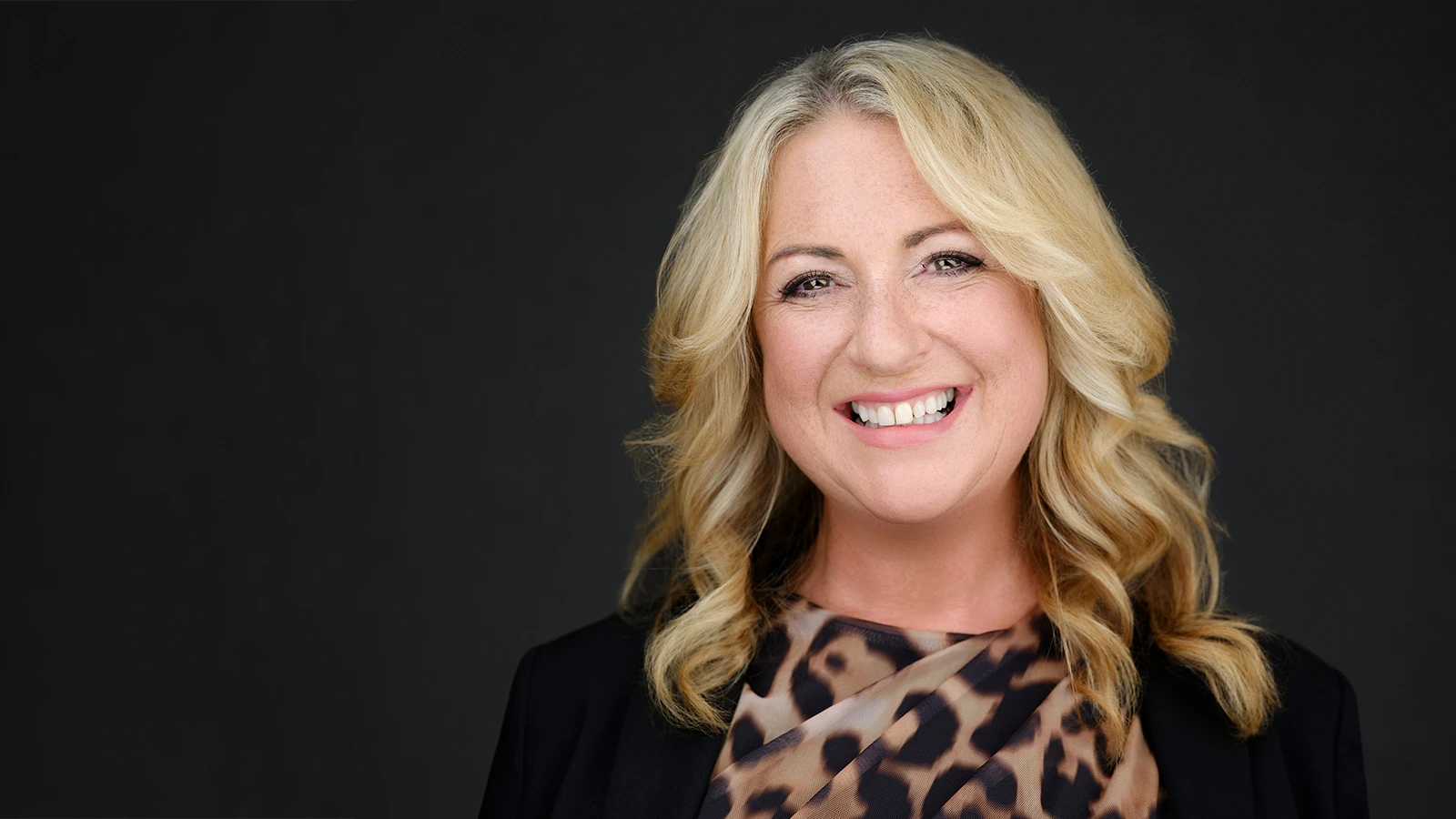 A professional business headshot session set up on location, the photographer reviewing images with the client