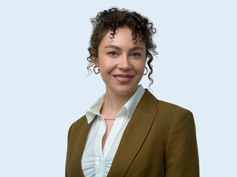 Corporate headshot on the brand-specified grey background