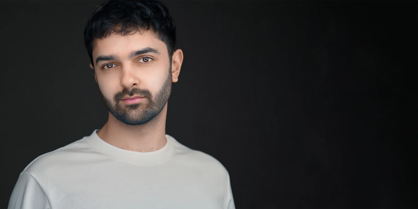 Professionally retouched headshot showing natural skin tone with blemishes gently removed