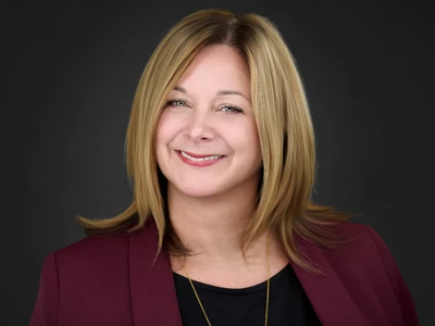 Woman in blazer, natural confident look, professional headshot