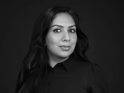 Monochrome headshot of a woman in a blouse, calm and direct expression