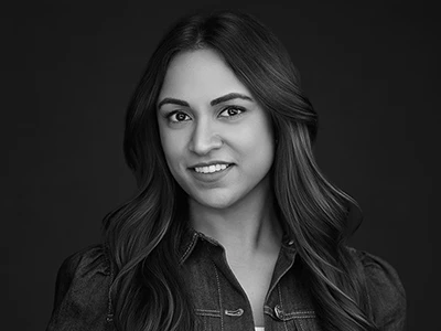 Monochrome headshot of a woman in a dress shirt, confident and professional