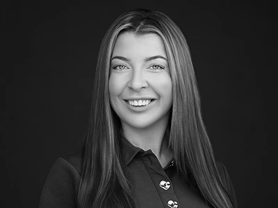 Monochrome portrait of a professional woman in a polo shirt, relaxed and confident