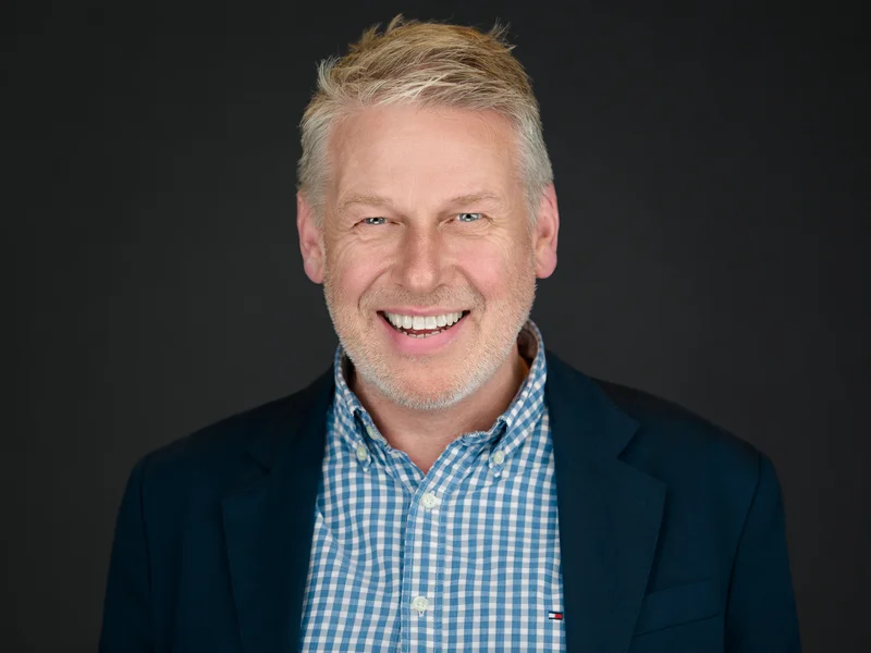 Cornwall corporate headshot of a bearded man in an open-collar dark grey blazer