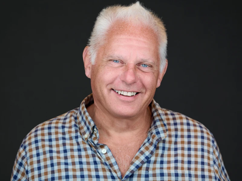 Man in a tailored dress shirt, calm professional expression — professional headshot
