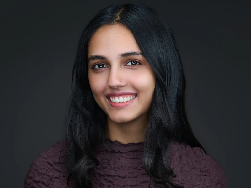Woman in a dark jumper, approachable professional portrait with a natural expression