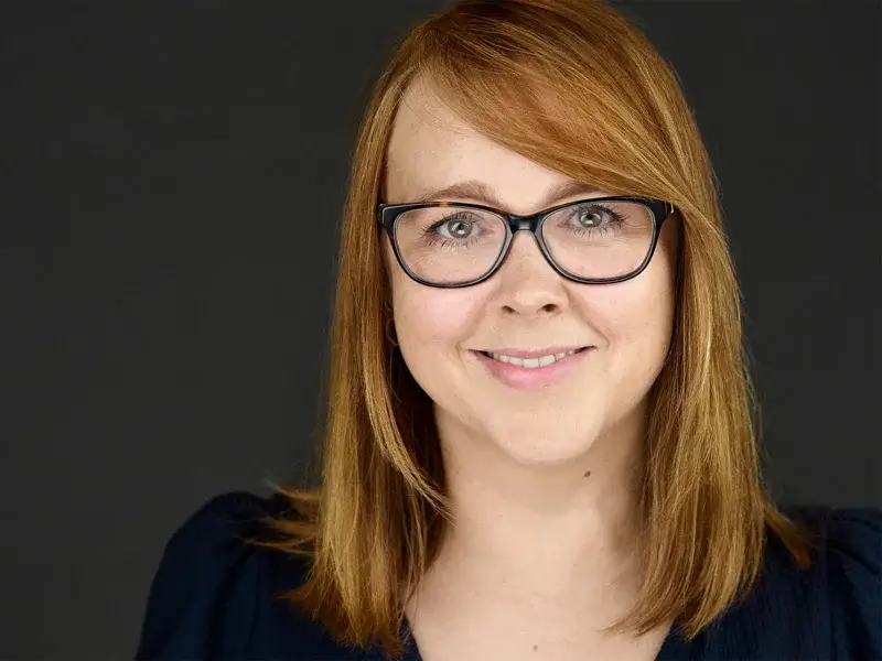 PR professional whose warm smile creates immediate trust in this professional headshot