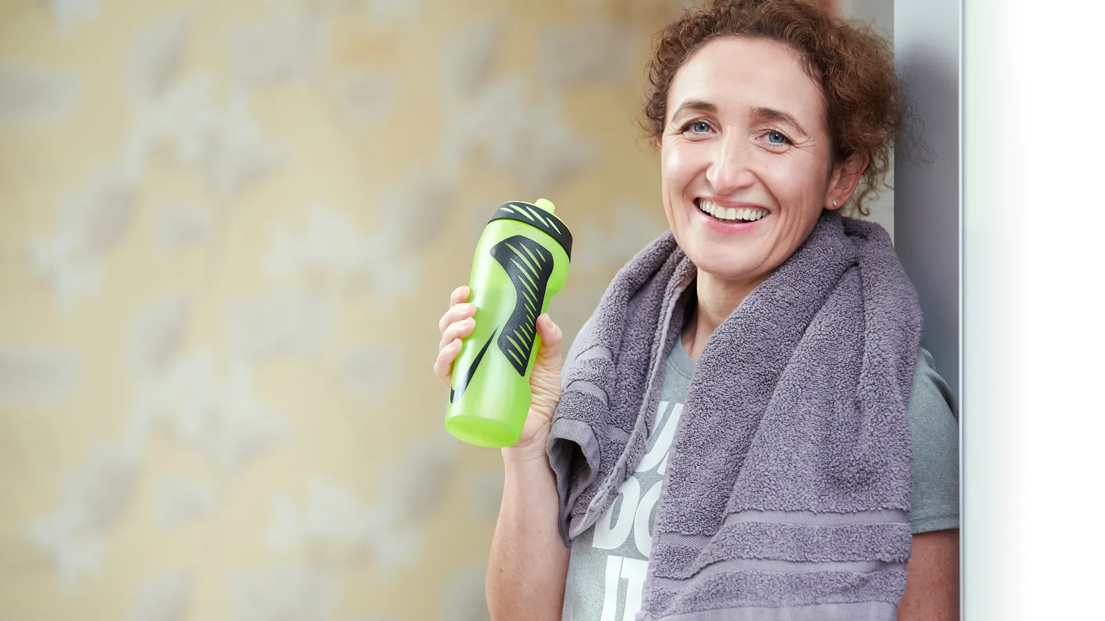 Personal branding portrait of a fitness professional with a water bottle and gym towel